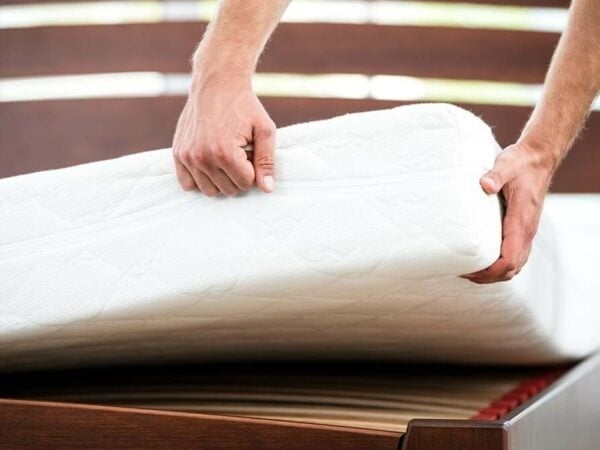 Man holding mattresses